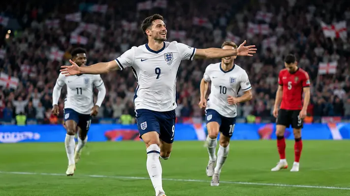 England vs Albania match at Wembley Stadium with an England player celebrating a goal in front of a packed crowd